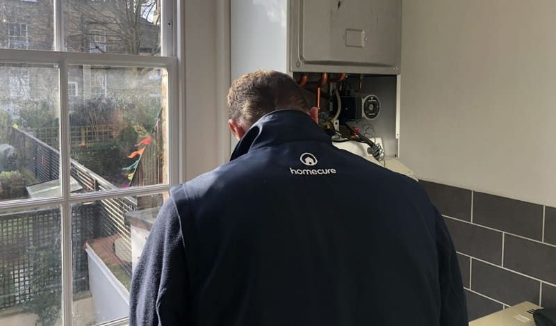 heating engineer working on boiler