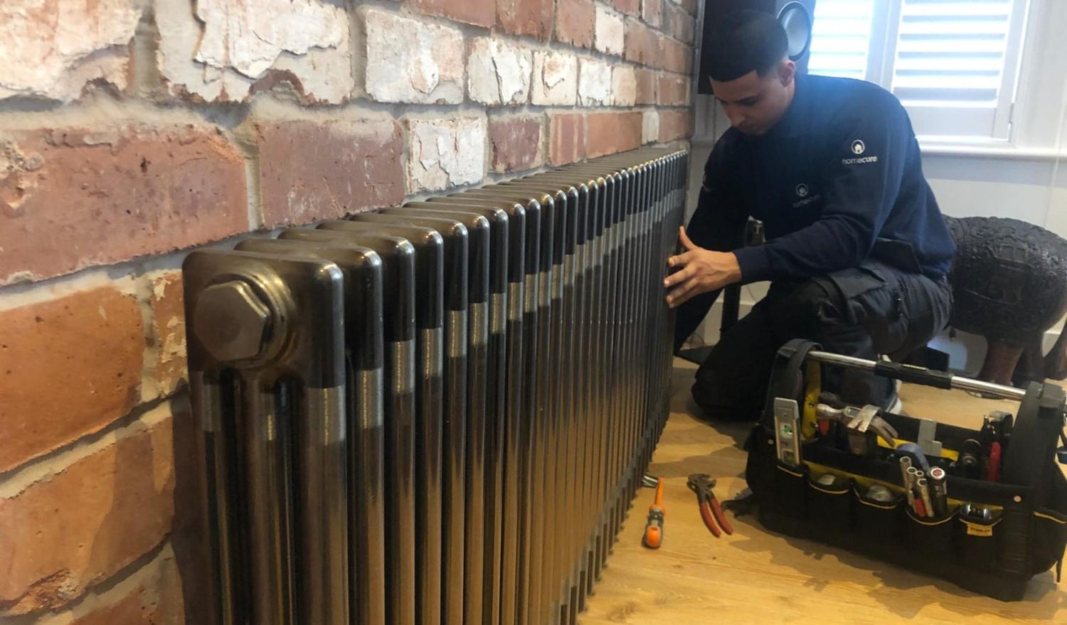 Homecure engineer providing a comprehensive power flush service in London