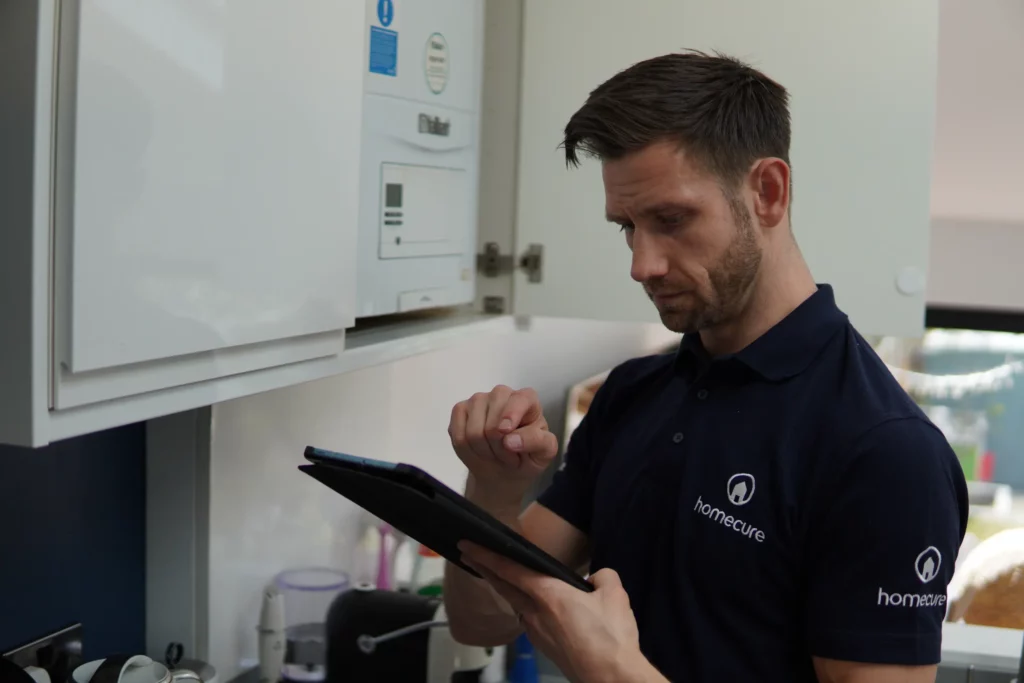 Homecure heating engineer in London servicing a boiler