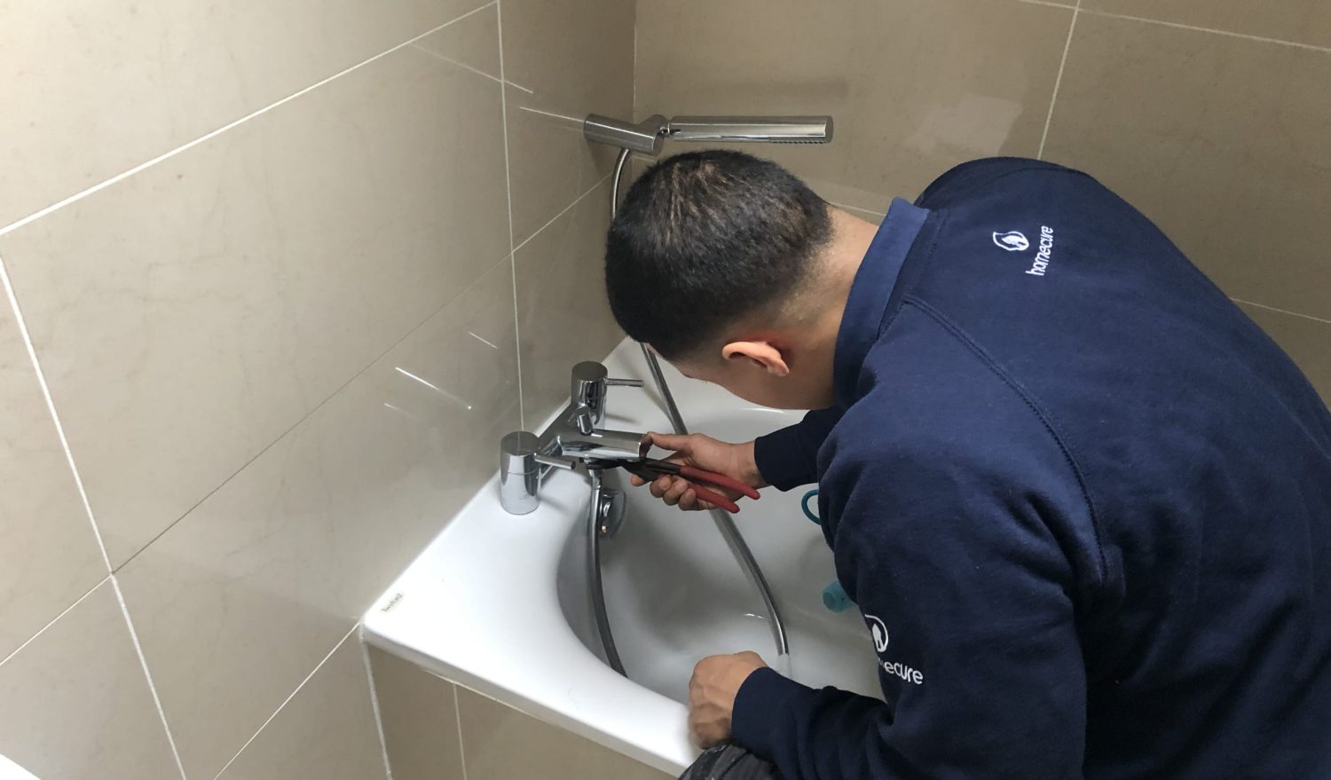 Our emergency plumber in Borehamwood fixing a tap