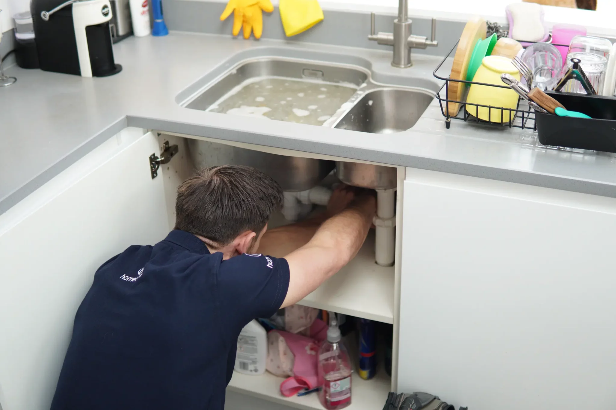 Plumber fixing a leaking sink in West London